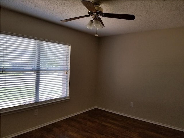 spare room with ceiling fan, dark hardwood / wood-style flooring, and a textured ceiling