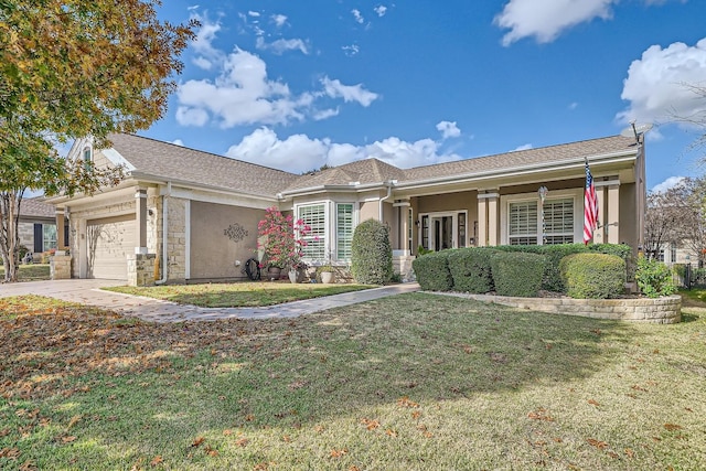 view of front of home featuring a garage and a front lawn