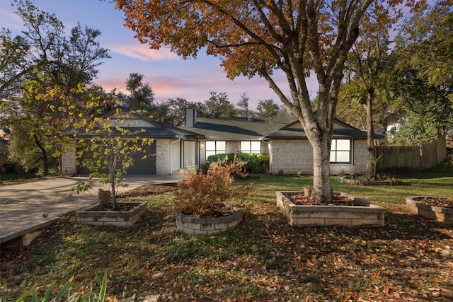 view of front facade featuring a garage and a lawn