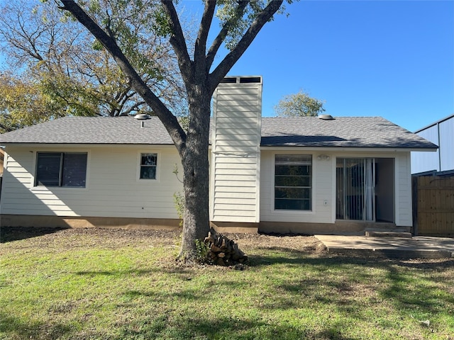 back of house featuring a lawn and a patio area