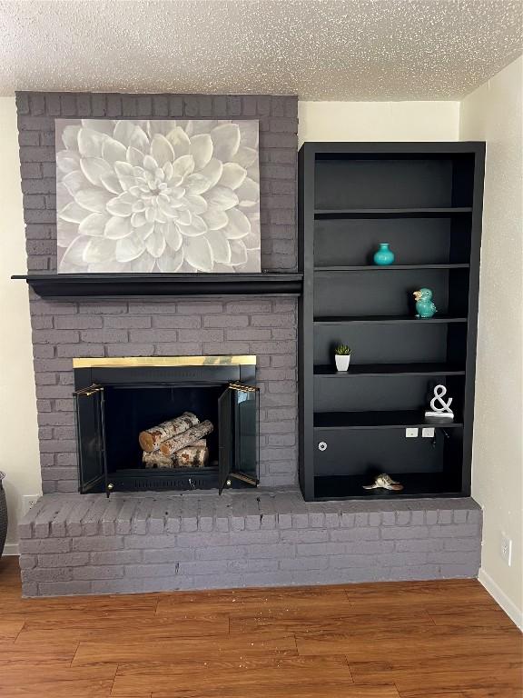 details featuring a fireplace, hardwood / wood-style floors, and a textured ceiling