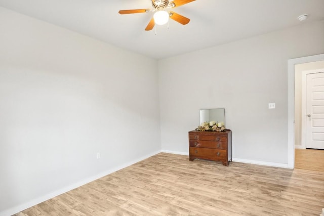 spare room featuring light hardwood / wood-style flooring and ceiling fan