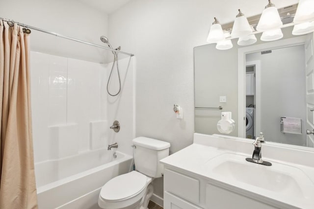 full bathroom with washer / clothes dryer, vanity, shower / bathtub combination with curtain, and toilet