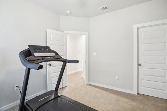 workout room featuring light colored carpet