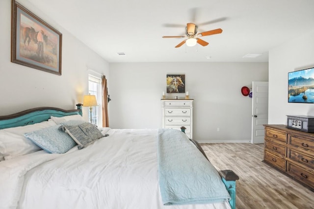 bedroom with ceiling fan and light hardwood / wood-style floors