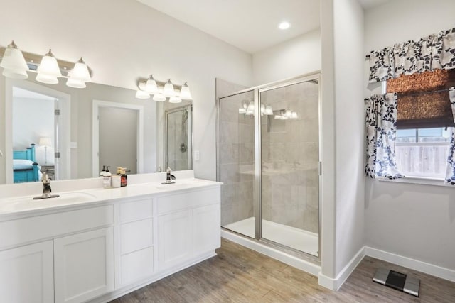 bathroom featuring hardwood / wood-style flooring, vanity, and an enclosed shower