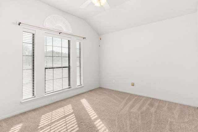 unfurnished room featuring ceiling fan, light colored carpet, and vaulted ceiling