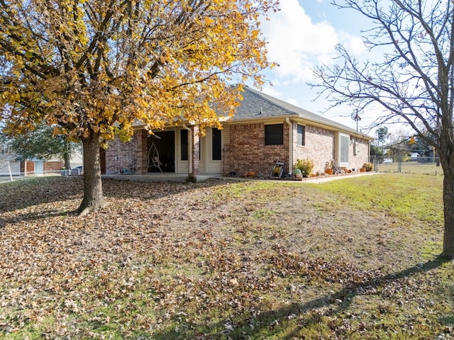 back of house featuring a patio area and a yard