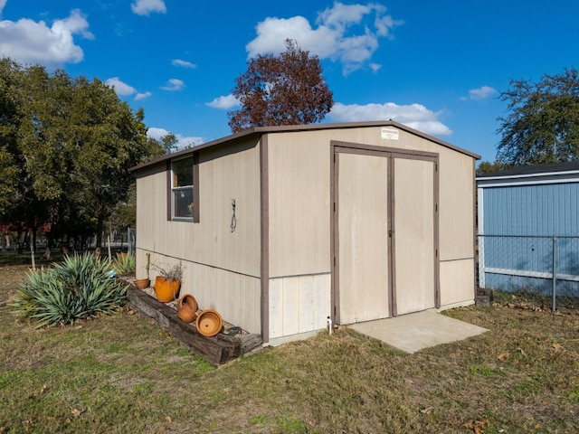 view of outdoor structure featuring a lawn