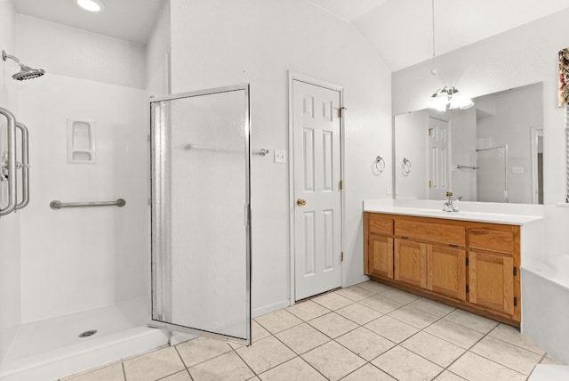 bathroom with tile patterned flooring, vanity, vaulted ceiling, and an enclosed shower