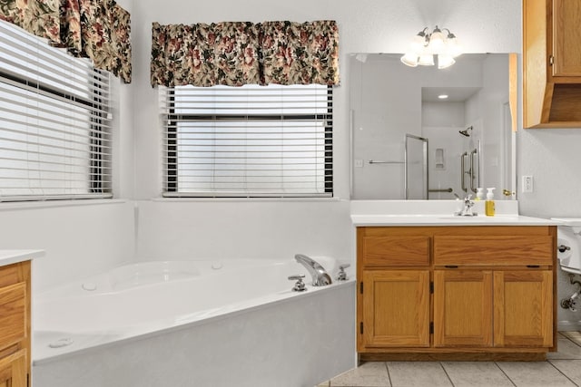 bathroom with shower with separate bathtub, vanity, tile patterned floors, and a notable chandelier