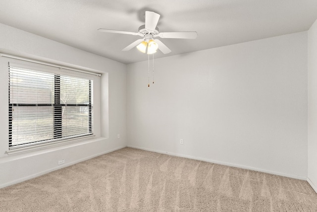 spare room featuring carpet flooring and ceiling fan