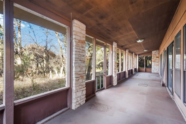 unfurnished sunroom with wood ceiling and lofted ceiling