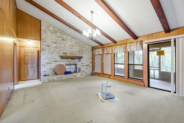 unfurnished living room with beam ceiling and wooden walls