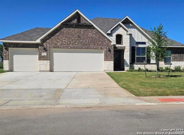 craftsman inspired home with a garage and a front yard