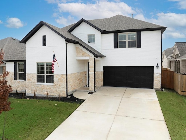 view of front of home featuring a garage and a front lawn