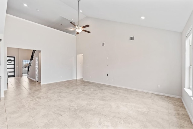 unfurnished room featuring ceiling fan, a wealth of natural light, and high vaulted ceiling