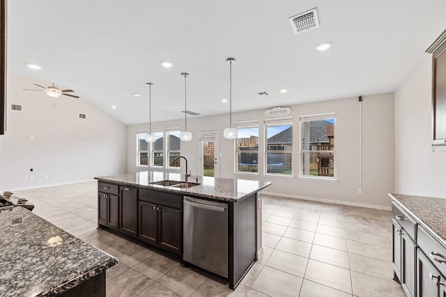 kitchen with sink, dark stone countertops, hanging light fixtures, a kitchen island with sink, and stainless steel dishwasher