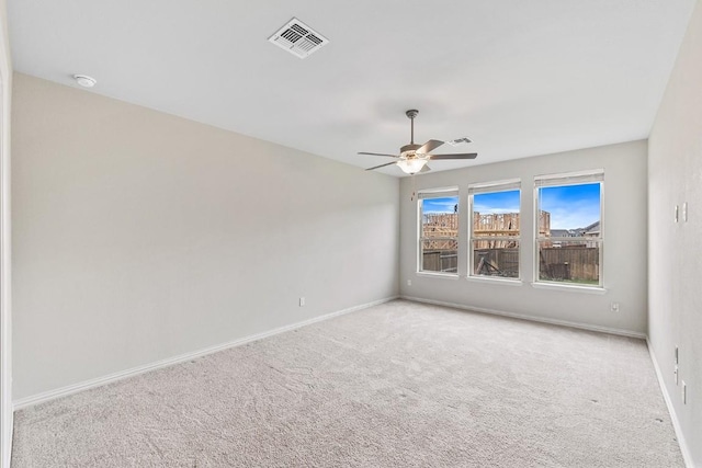 carpeted spare room with ceiling fan