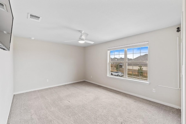 unfurnished room featuring ceiling fan and carpet flooring