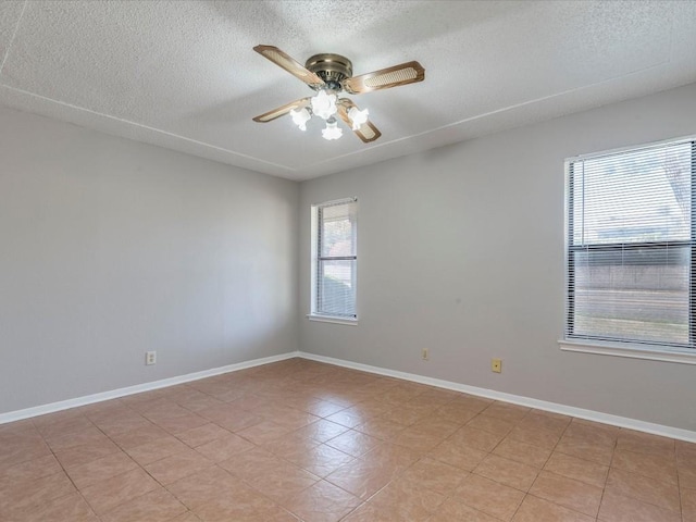 empty room with a textured ceiling and ceiling fan