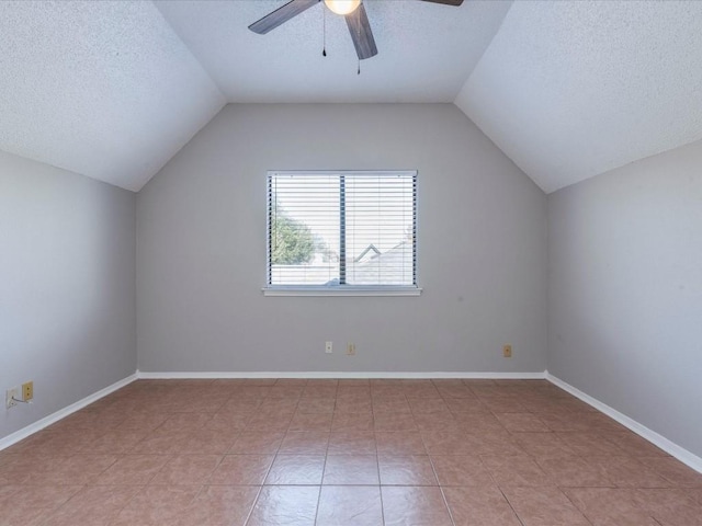 bonus room featuring a textured ceiling, vaulted ceiling, ceiling fan, and light tile patterned flooring