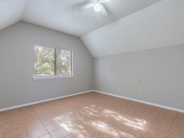 bonus room with ceiling fan, light tile patterned flooring, lofted ceiling, and a textured ceiling