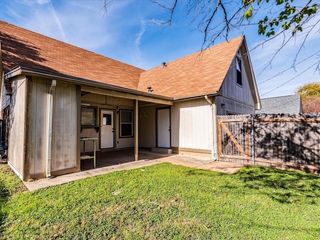 back of property featuring a lawn and a patio