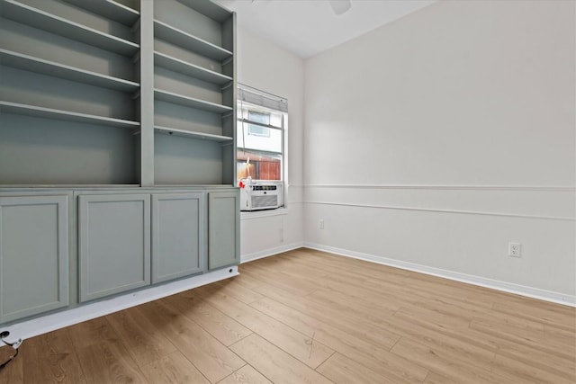 spare room featuring cooling unit and light hardwood / wood-style flooring