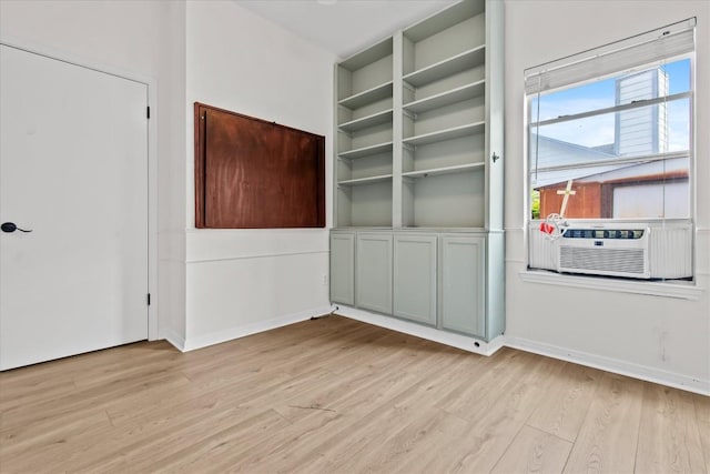 interior space with light hardwood / wood-style floors and cooling unit