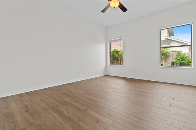 empty room with light hardwood / wood-style flooring and ceiling fan