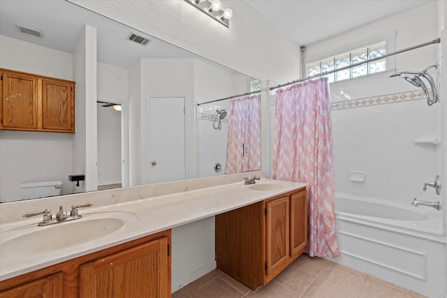 full bathroom with tile patterned flooring, vanity, shower / tub combo, and toilet