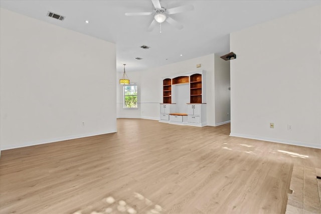 unfurnished living room featuring ceiling fan and light wood-type flooring