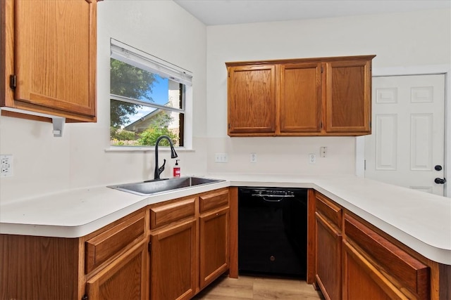 kitchen with dishwasher, light wood-type flooring, kitchen peninsula, and sink