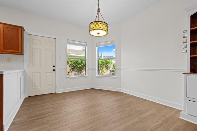 unfurnished dining area with light hardwood / wood-style flooring