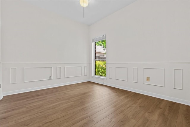 spare room featuring wood-type flooring