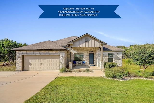 view of front of property with a garage and a front yard