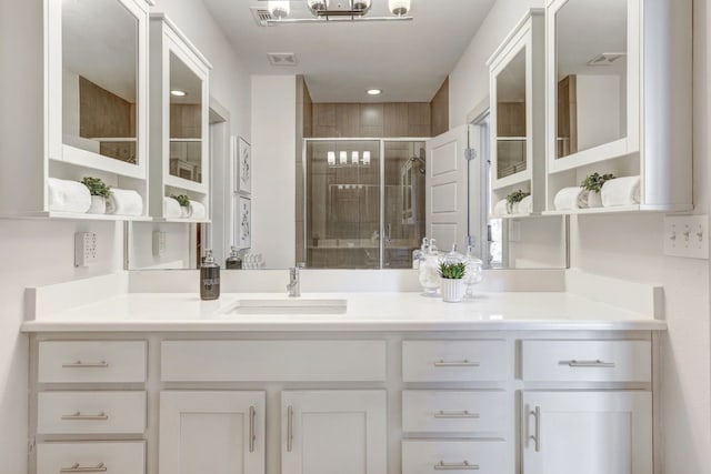 bathroom featuring vanity and an enclosed shower