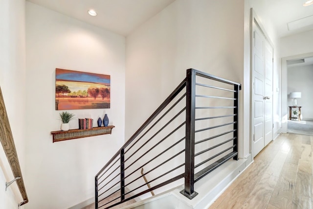 staircase with hardwood / wood-style flooring