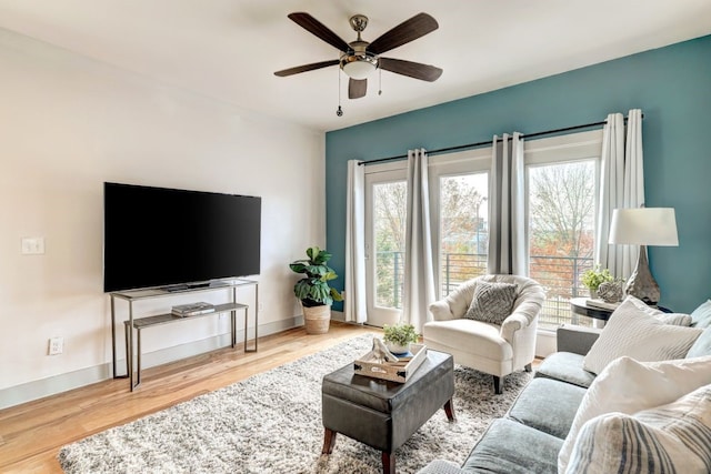 living room featuring ceiling fan and light wood-type flooring