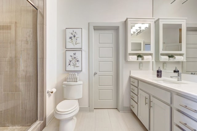 bathroom featuring tiled shower, vanity, toilet, and tile patterned flooring