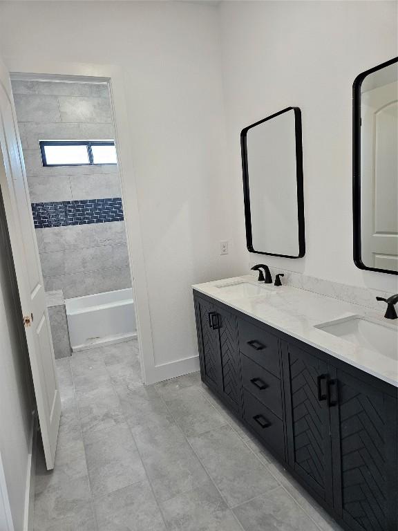 bathroom with vanity and tiled shower / bath combo