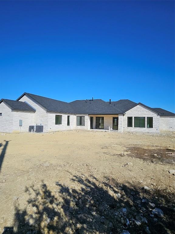 rear view of property with cooling unit