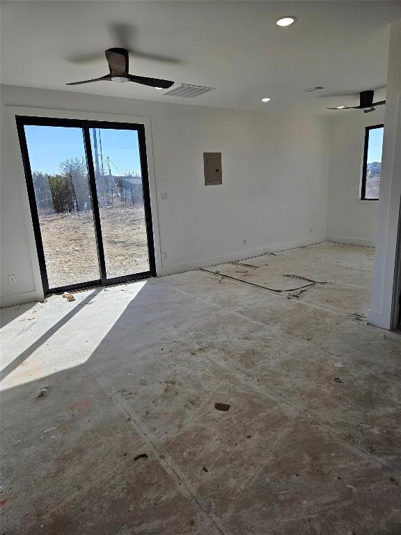 spare room featuring electric panel and ceiling fan