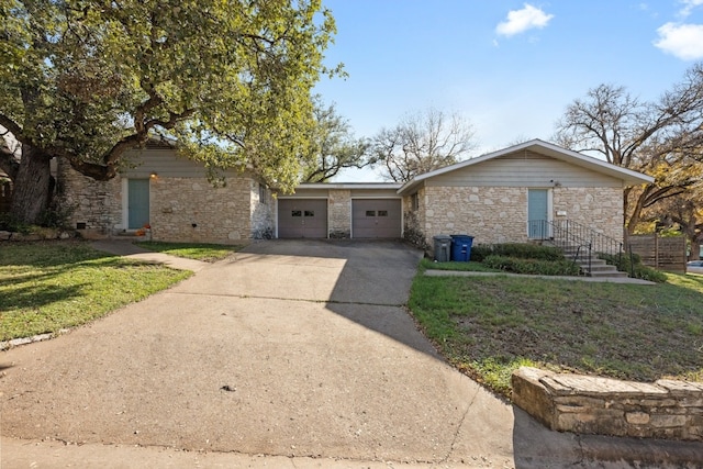 ranch-style house featuring a front yard and a garage