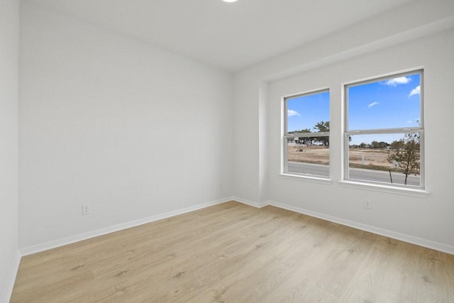 spare room with light hardwood / wood-style floors