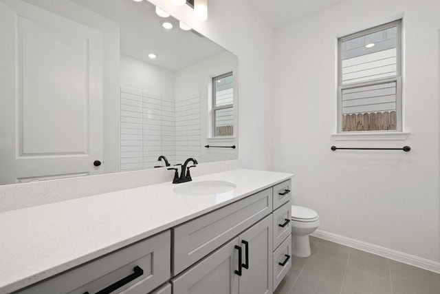 bathroom with tile patterned flooring, vanity, and toilet