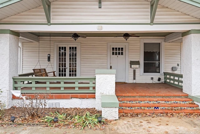 entrance to property featuring ceiling fan and a porch