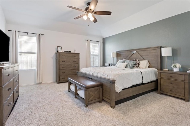 bedroom with light colored carpet, ceiling fan, and lofted ceiling