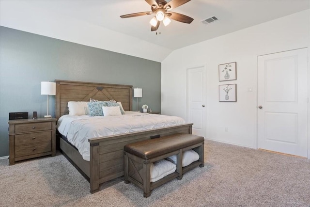 bedroom featuring ceiling fan, light colored carpet, and vaulted ceiling